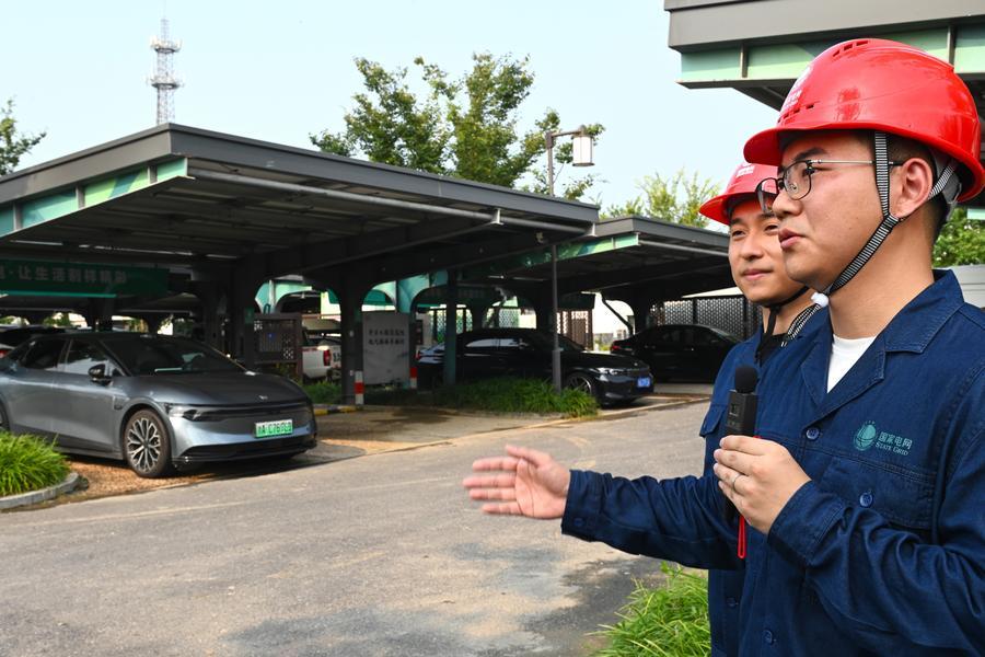 A technician introduces an integrated photovoltaic charging and storage station in Meilin Village, Xiaoshan District of Hangzhou, east China's Zhejiang Province, on Aug. 4, 2025. (Photo/Xinhua)